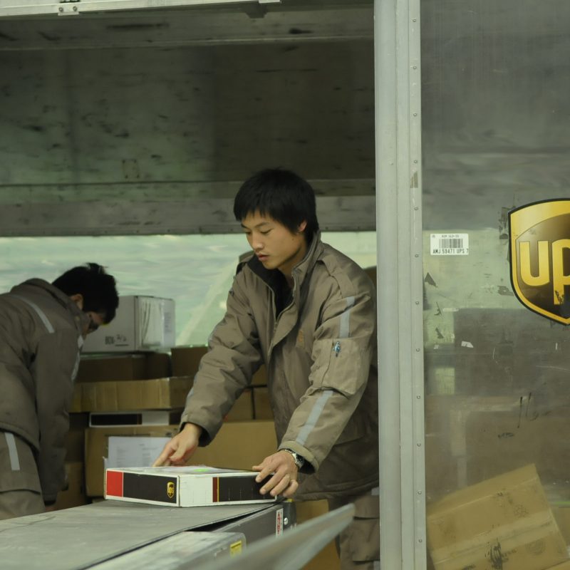 Staff loading a UPS aircraft container in Shanghai China bound for export