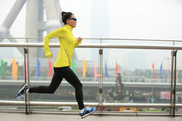 young fitness woman runner running at shanghai city